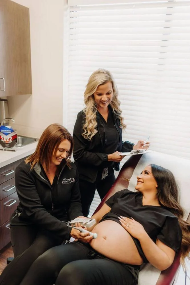 Team checking on pregnant mothers belly